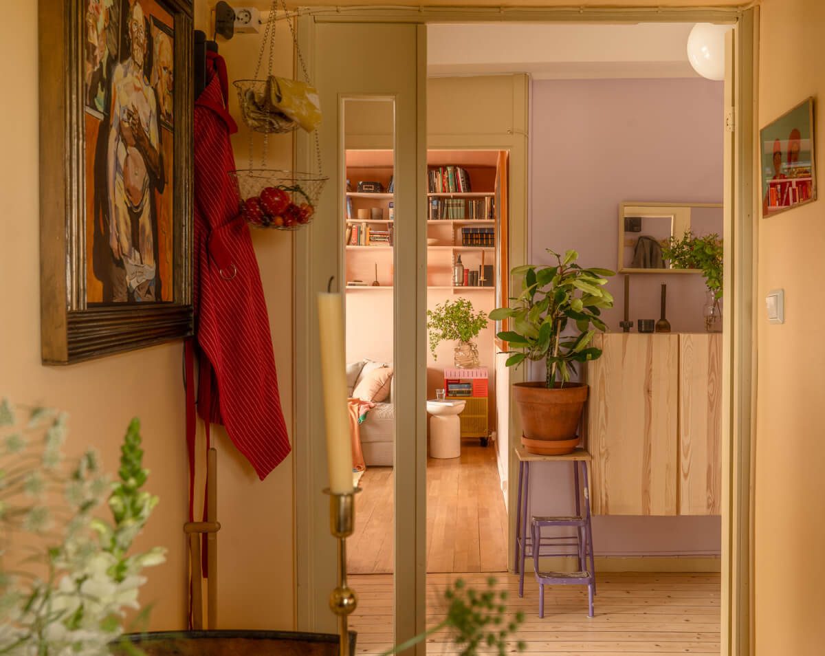 A Stylish and Joyful Color and Material Palette in a Midcentury Apartment 16 kitchen view into hall and living room