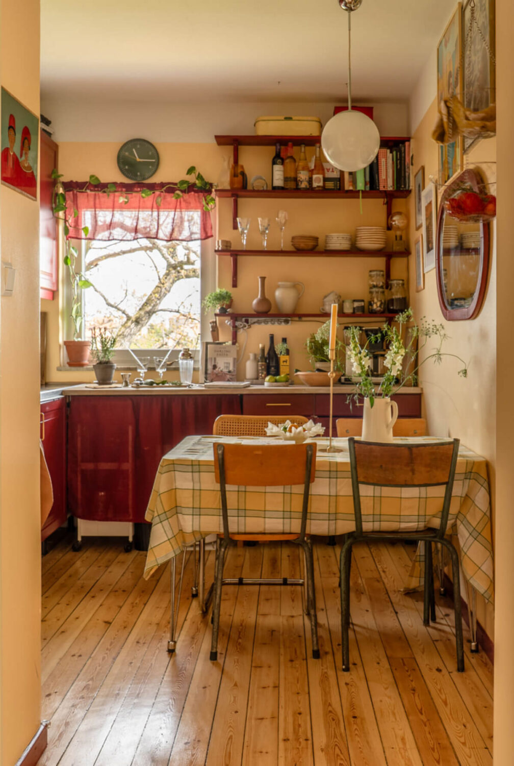 Best of 2025: Kitchens 105 kitchen with dining table wooden floor deep red cabinets and shelves