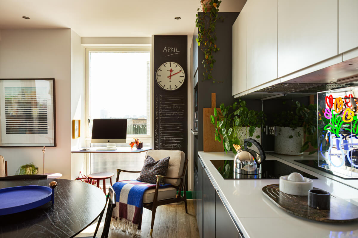 Playful Colors in a Modern One-Bedroom Apartment in London 10 kitchen with home office in front of window