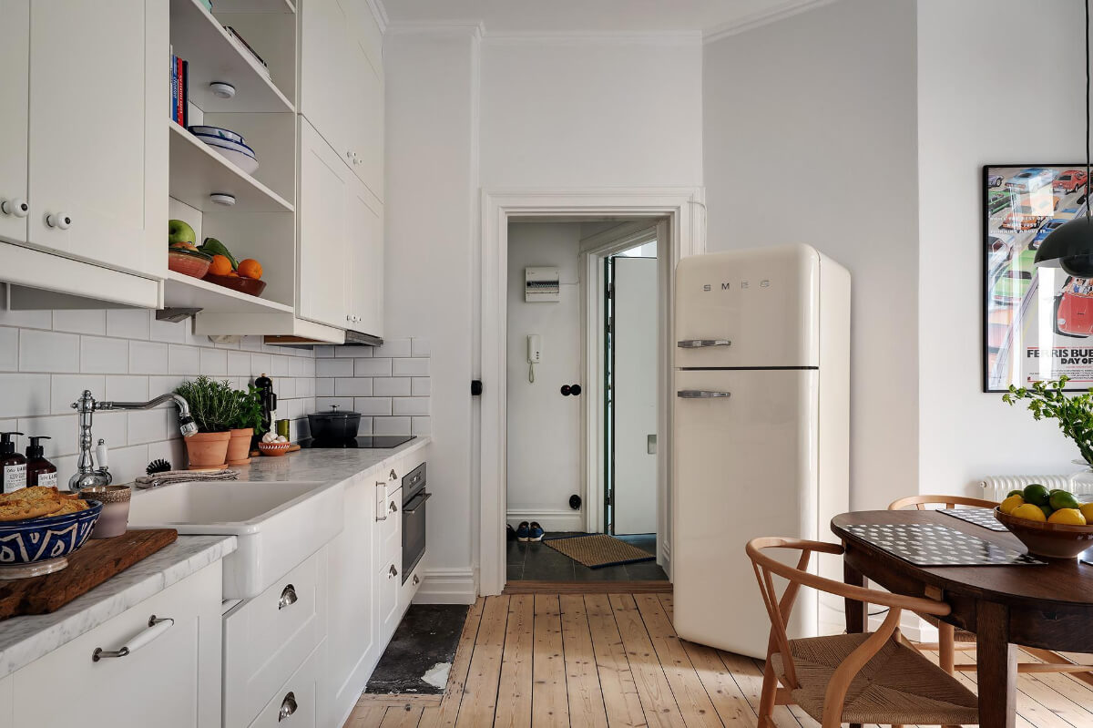Classic Elements in a Charming Swedish Studio Apartment 22 kitchen with smeg fridge