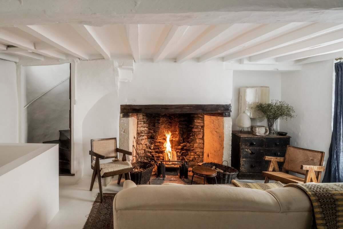 White-Washed Walls and Rustic Elements in a 17th Century Townhouse 2 large brick fireplace living room white walls and wooden beams