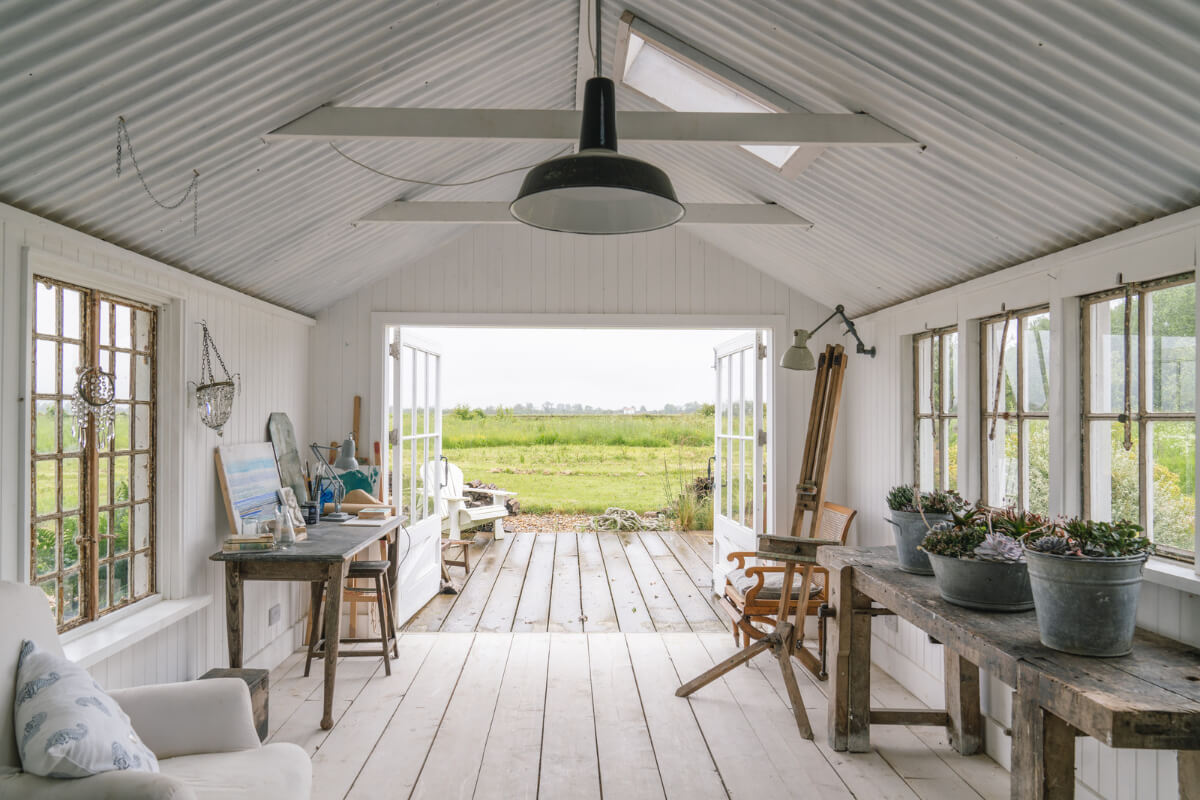 A Bright New England-Style Home with a Lush Garden 28 large glass doors white cottage