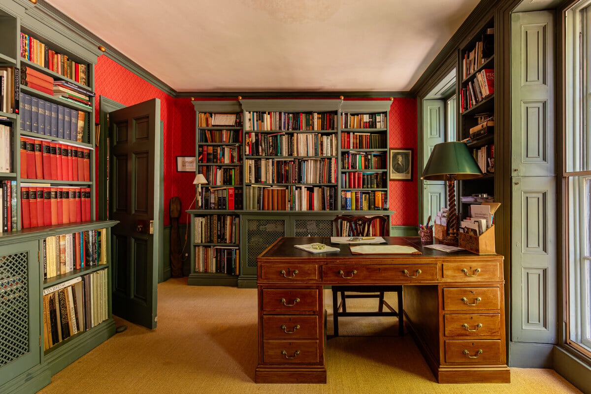 A Carefully Restored Georgian Townhouse in East London 17 library room green woodwork red wallpaper