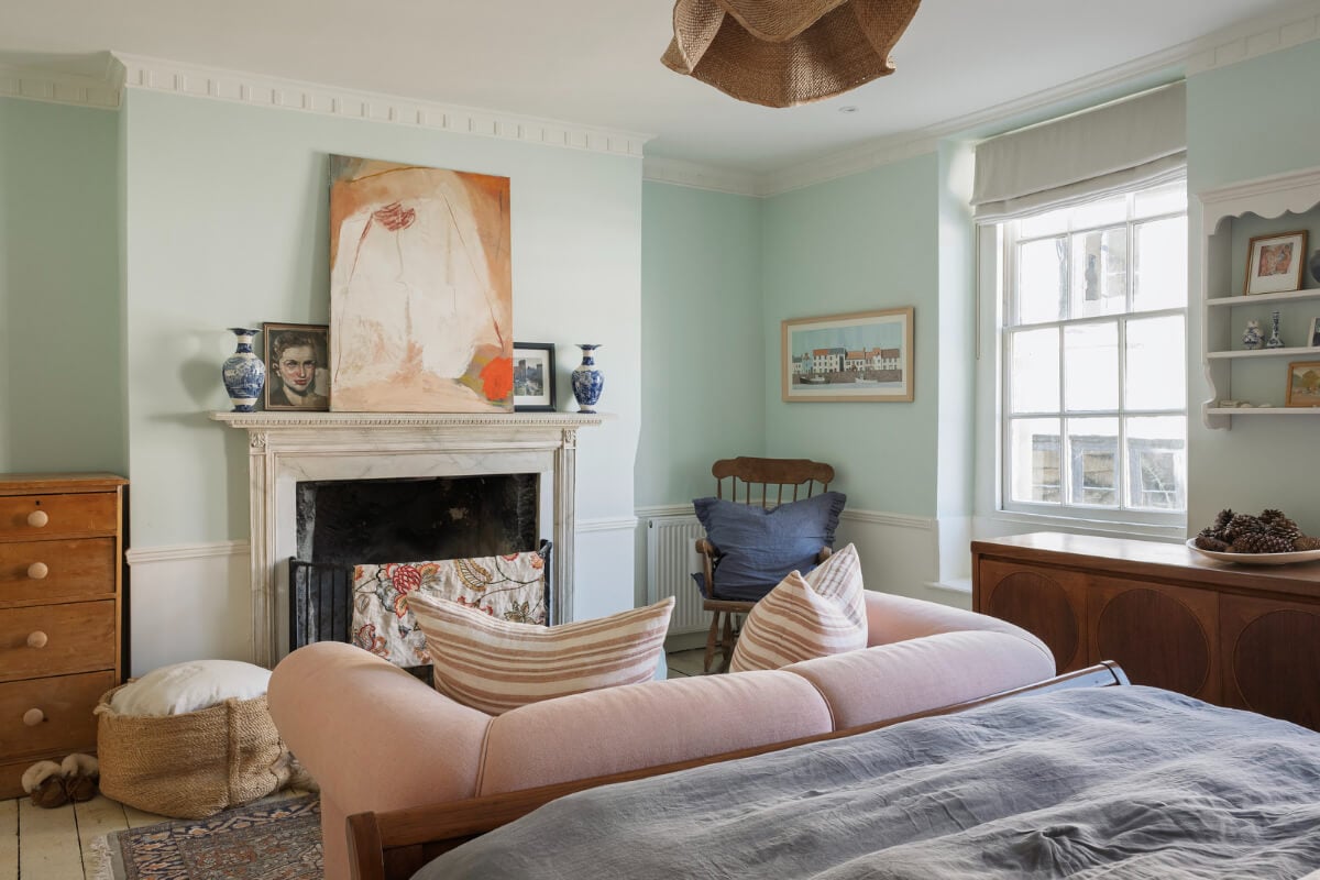 A Family Home with a Cheerful Color Palette in a Historic House 16 light blue bedroom with pink sofa and fireplace
