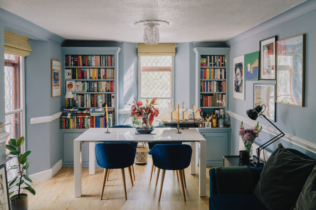 A Colorful Apartment in a Former Victorian Church in London 2 light blue living room bookshelves