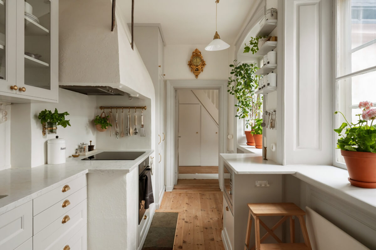A Charming Attic Apartment in Stockholm's Gamla Stan 7 light kitchen brass fittings wooden floor