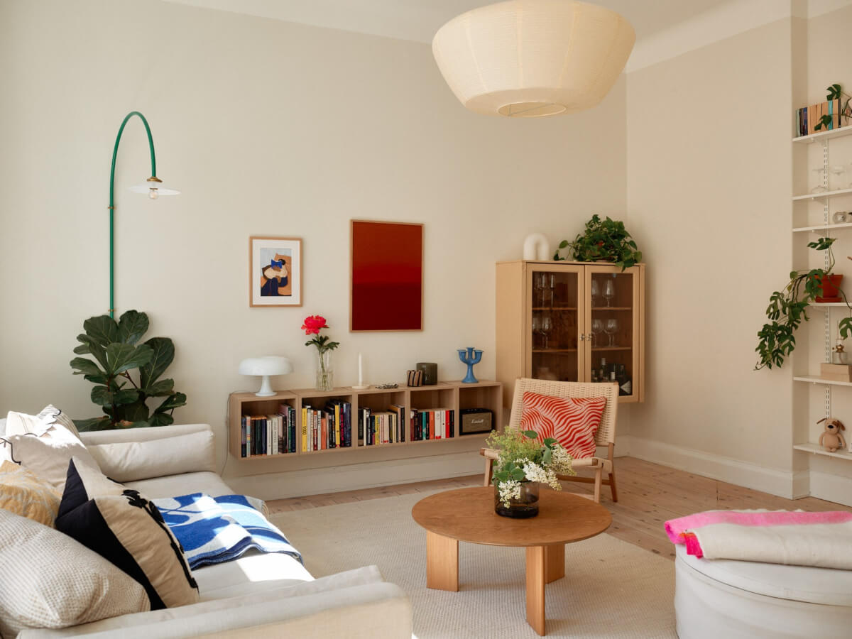 A Light-Filled Stockholm Apartment with Bright Color Pops 7 light living room bookshelves