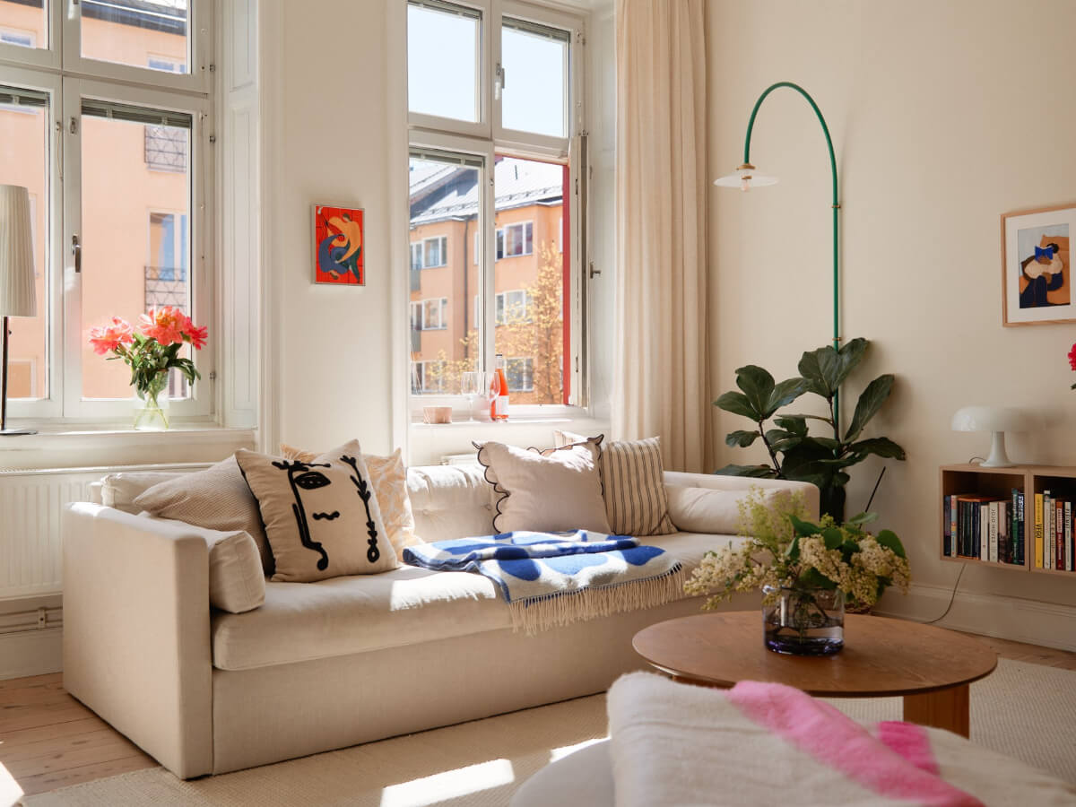 A Light-Filled Stockholm Apartment with Bright Color Pops 2 light scandi living room