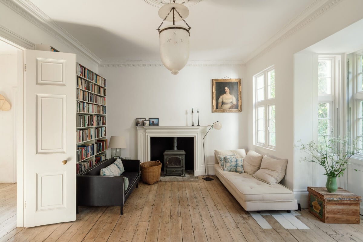 Grand, Light-Filled Spaces in a Gothic-Style English Coastal Home 3 living room fireplace bookcases