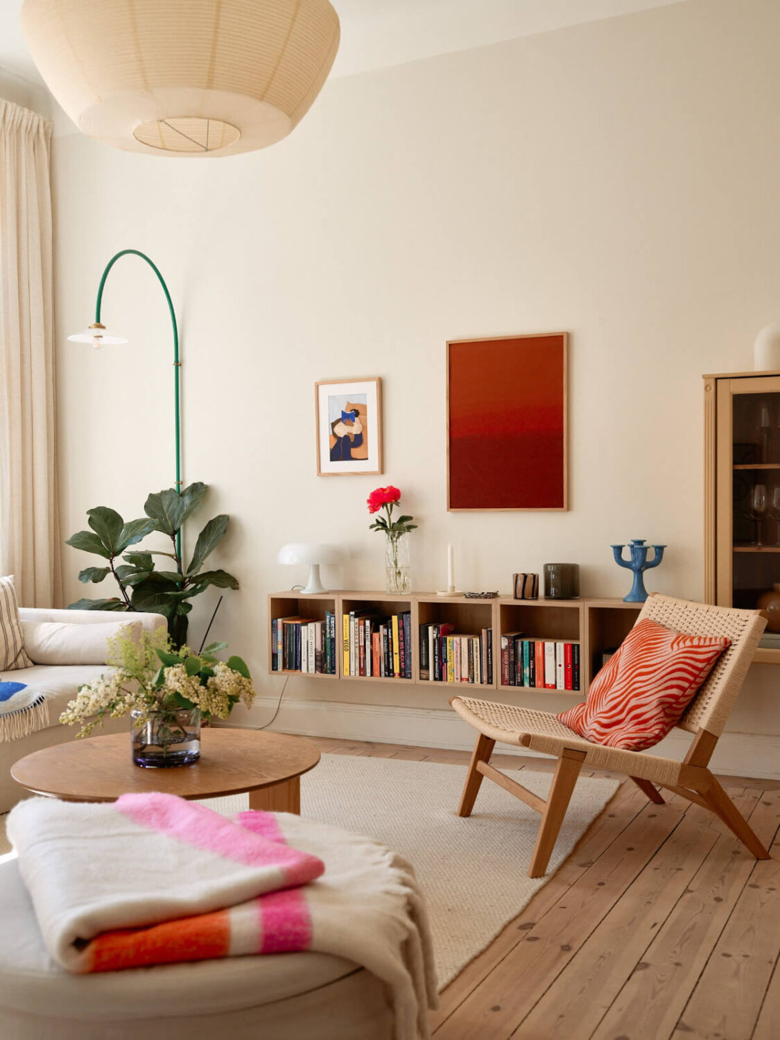 A Light-Filled Stockholm Apartment with Bright Color Pops 3 living room floating bookcase