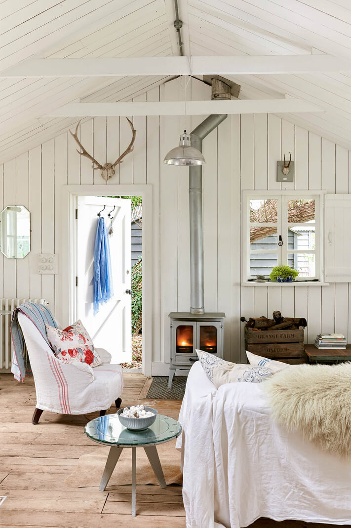 A Bright New England-Style Home with a Lush Garden 18 living room rustic floorboards log burner