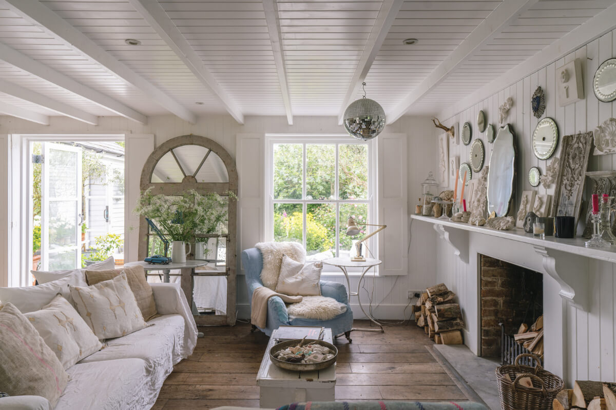 A Bright New England-Style Home with a Lush Garden 7 living room rustic wooden floorboards fireplace