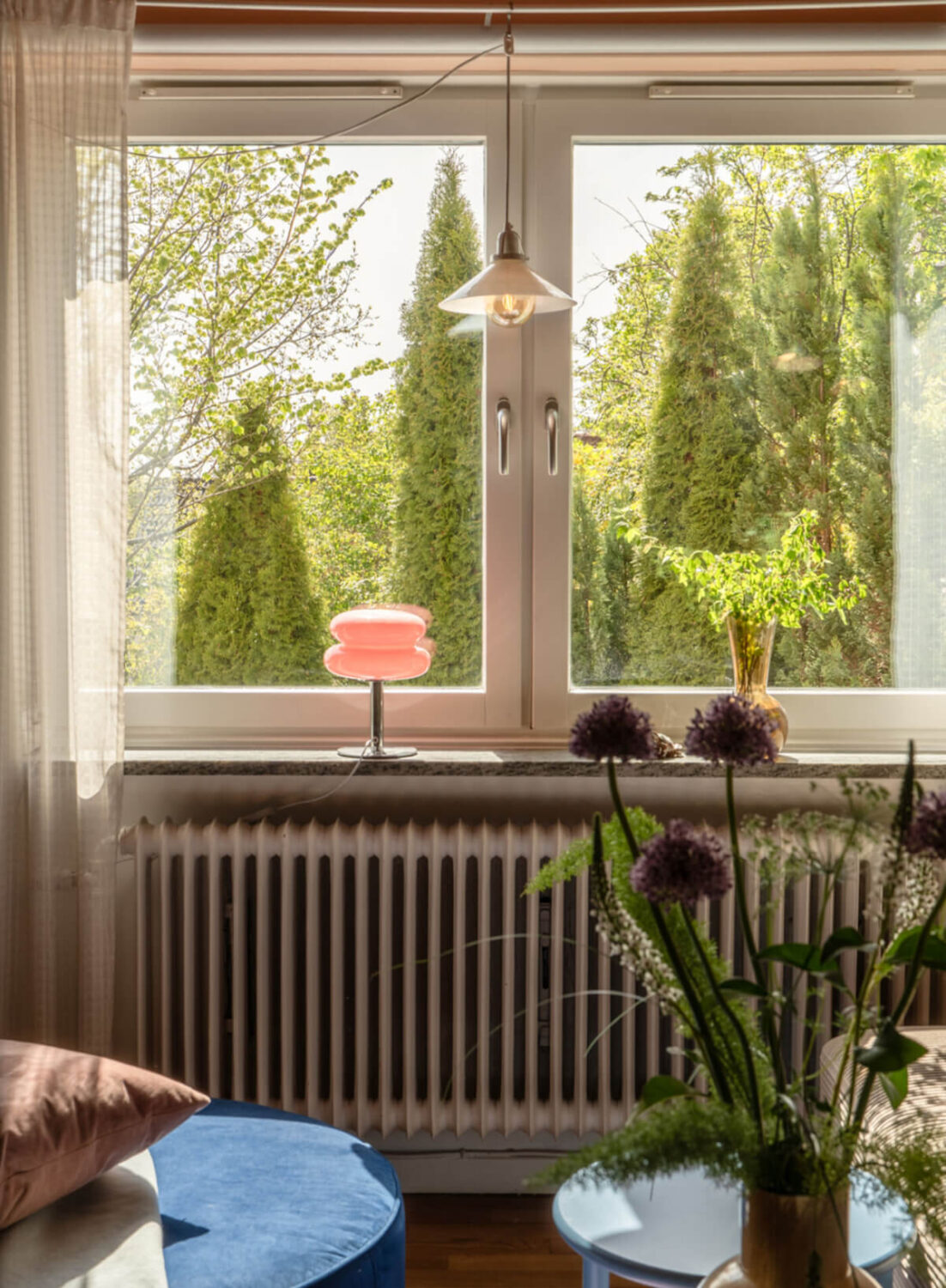 A Stylish and Joyful Color and Material Palette in a Midcentury Apartment 4 living room window pink lamp