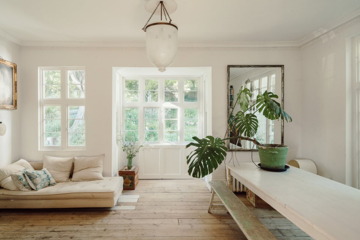 Grand, Light-Filled Spaces in a Gothic-Style English Coastal Home 2 living room wooden floorboards large table
