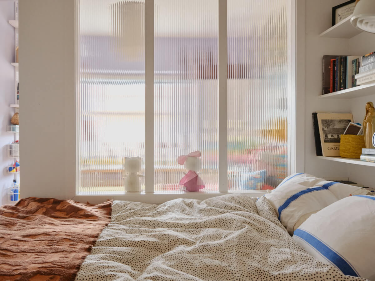 A Colorful 1940s Apartment with Original Elements 26 master bedroom ribbed glass room divider shelves