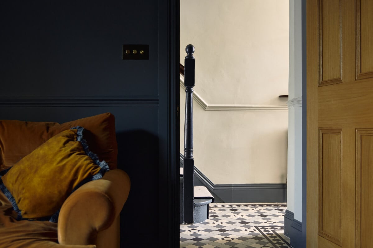 Moody Tones in a Restored and Extended Victorian Home in London 12 moody sitting room wooden door ochre sofa