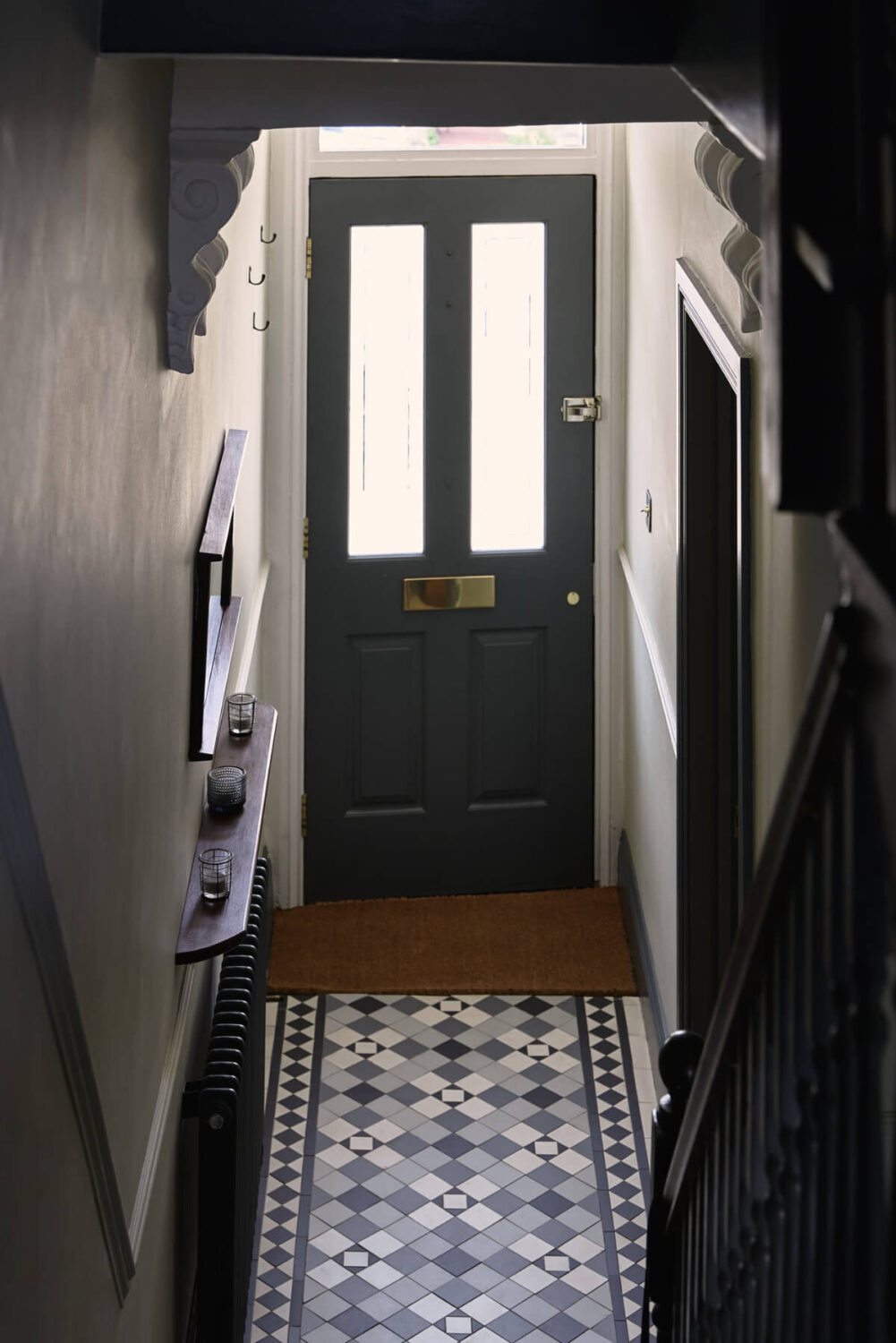 Moody Tones in a Restored and Extended Victorian Home in London 16 narrow hall small shelf floor tiles