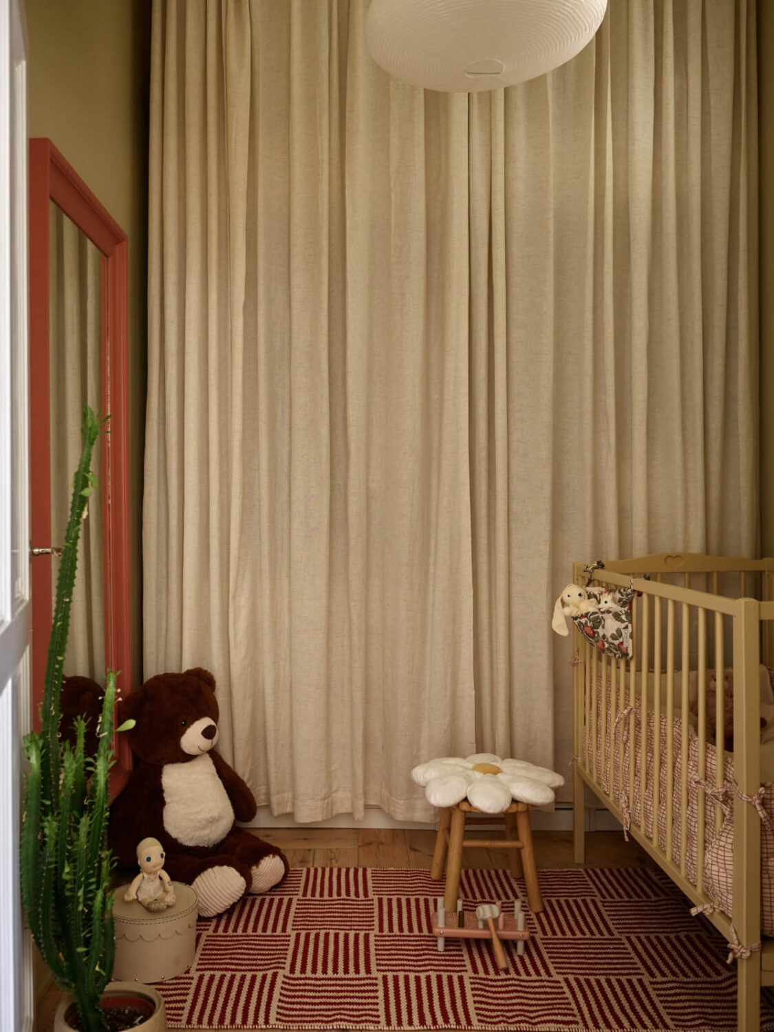 A Light-Filled Stockholm Apartment with Bright Color Pops 15 nursery wardrobes behind curtain striped rug