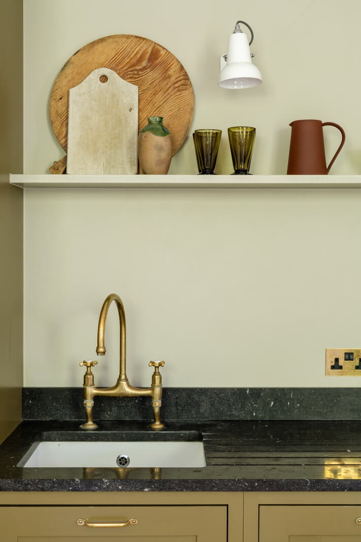 Contemporary and Classic Design in a Two-Bedroom London Duplex 7 olive green kitchen brass handles belgian limestone countertop