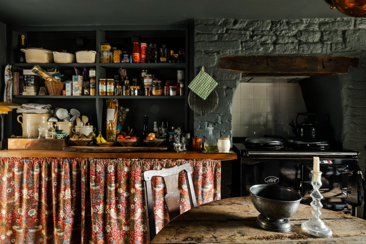 White-Washed Walls and Rustic Elements in a 17th Century Townhouse 15 open cabinets colorful curtains dark blue kitchen