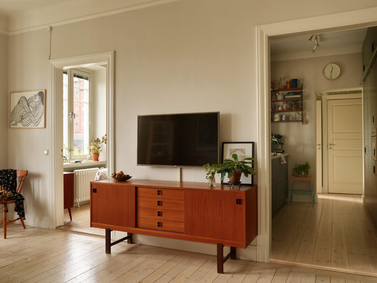 A Beautifully Renovated Early 20th-Century Apartment 11 open doorway living room kitchen