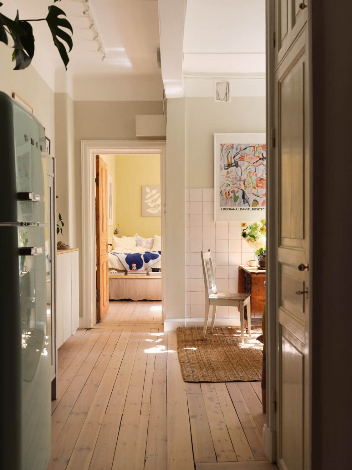 A Cozy, Tiny Apartment with a Golden Yellow Bedroom 10 open plan kitchen living and dining space wooden floorboards