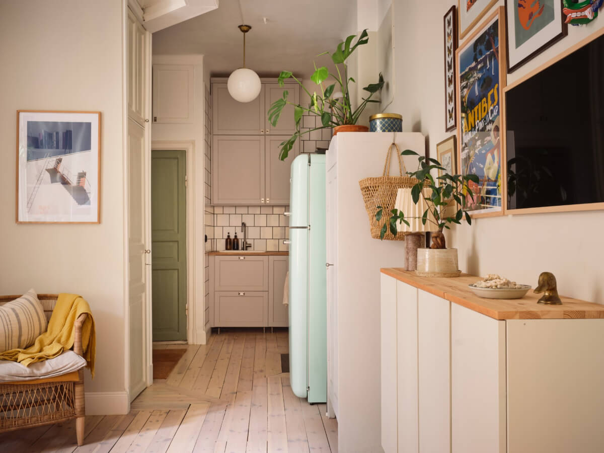 A Cozy, Tiny Apartment with a Golden Yellow Bedroom 5 open plan living room kitchen light wooden floorboards