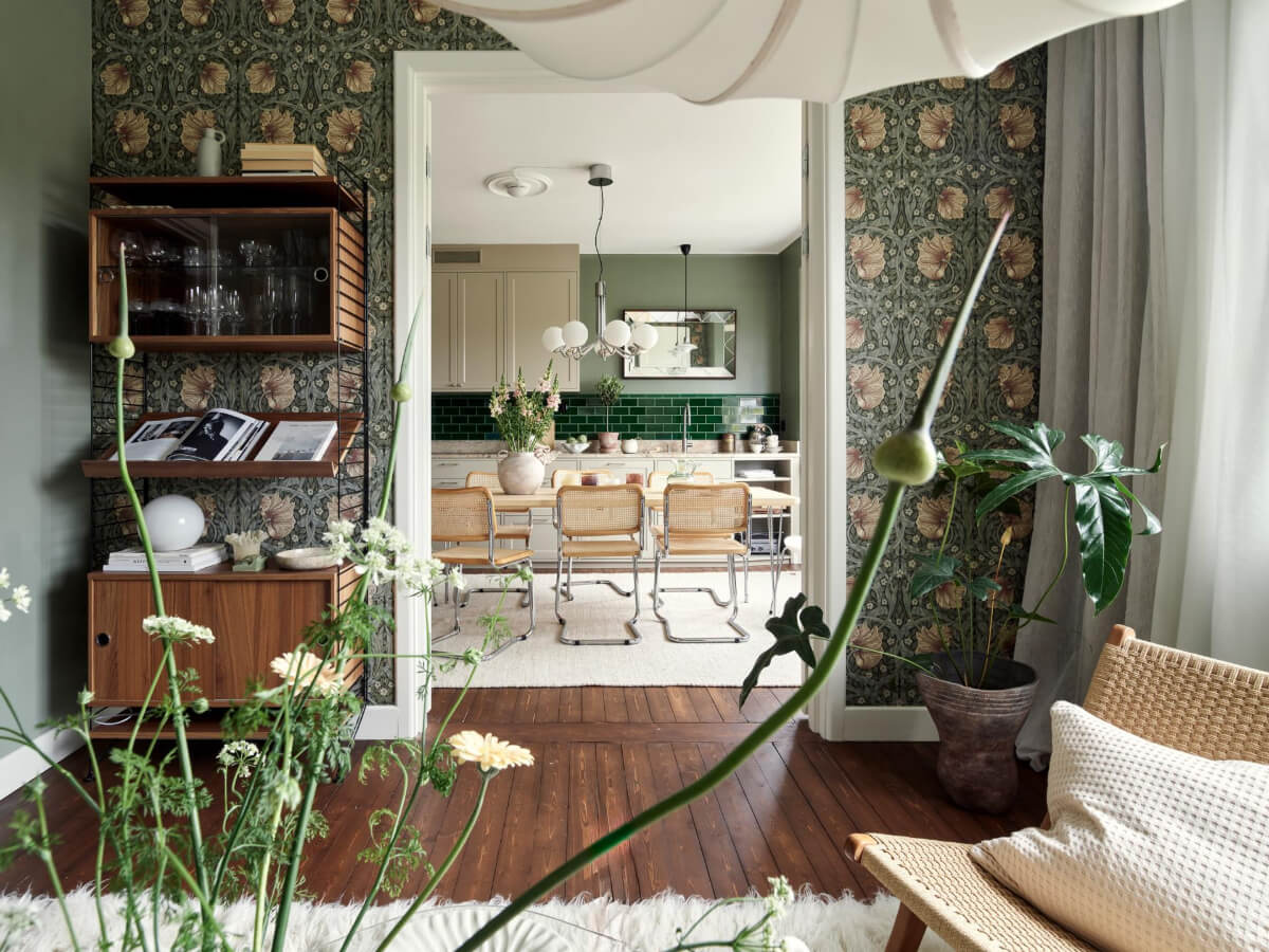 A Harmonious Color Palette in a Swedish Duplex Apartment 8 open plan living space kitchen warm wooden floorboards william morris wallpaper