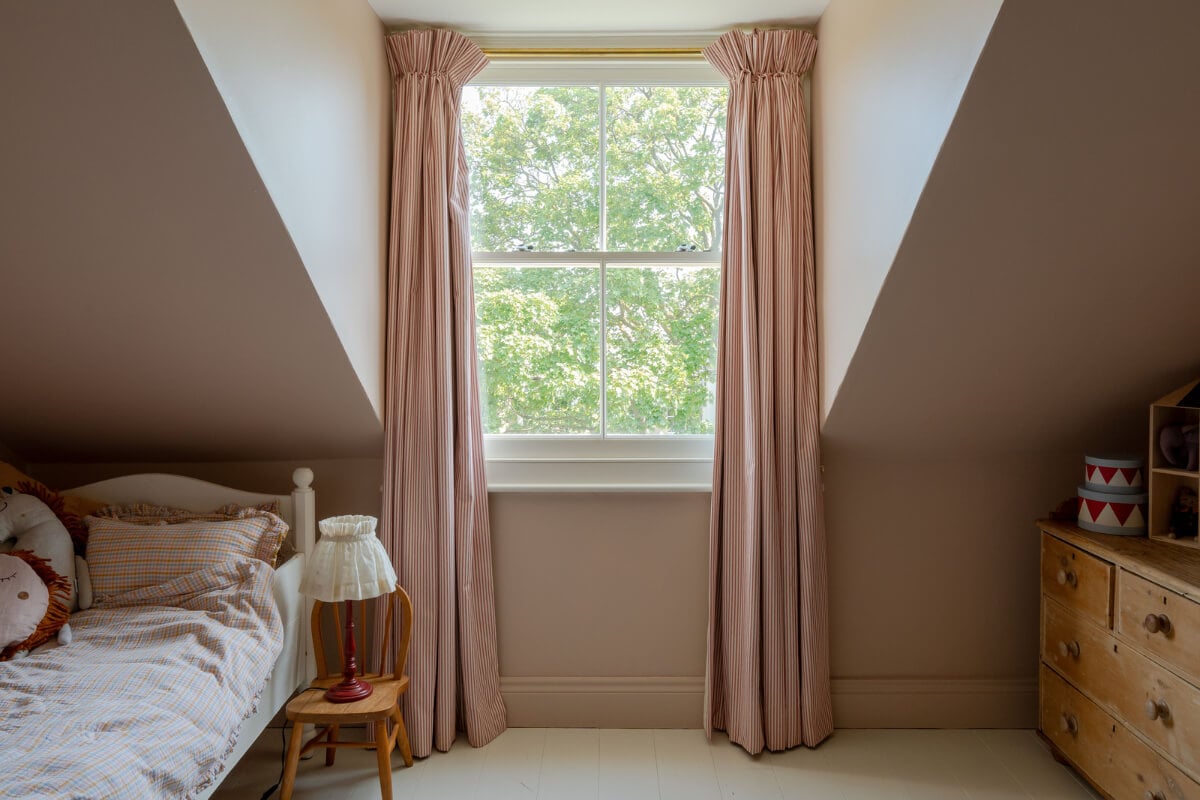 Contemporary and Classic Design in a Two-Bedroom London Duplex 17 pink kids bedroom white floorboard domer window