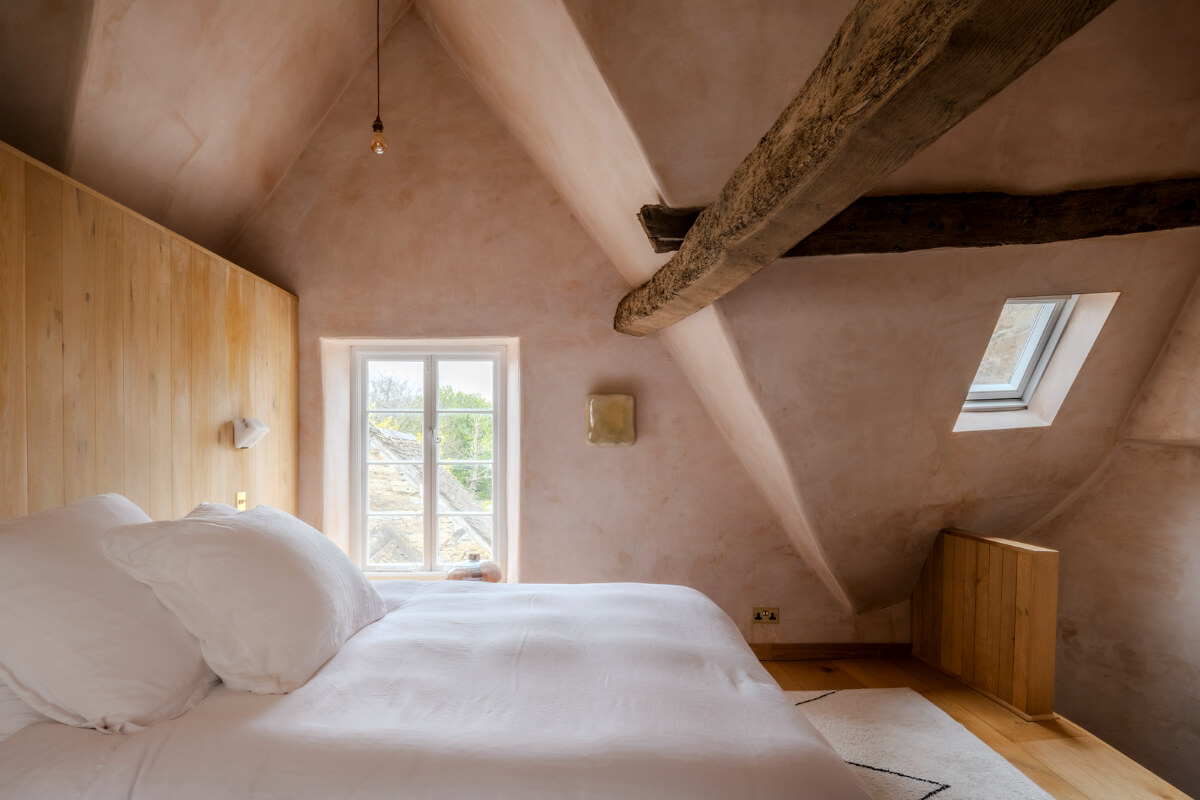 White-Washed Walls and Rustic Elements in a 17th Century Townhouse 21 pink plaster walls bedroom high ceiling wooden beams