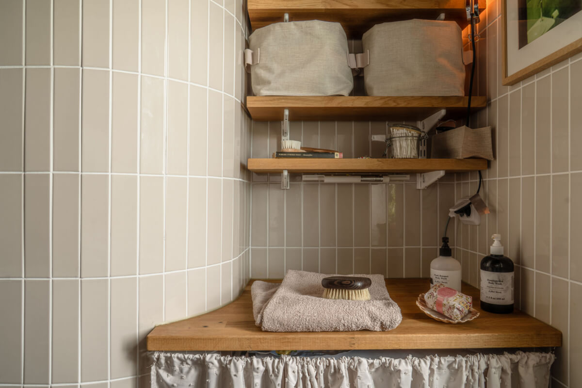 A Stylish and Joyful Color and Material Palette in a Midcentury Apartment 28 rounded bathroom wall washing machine hidden with curtain shelves