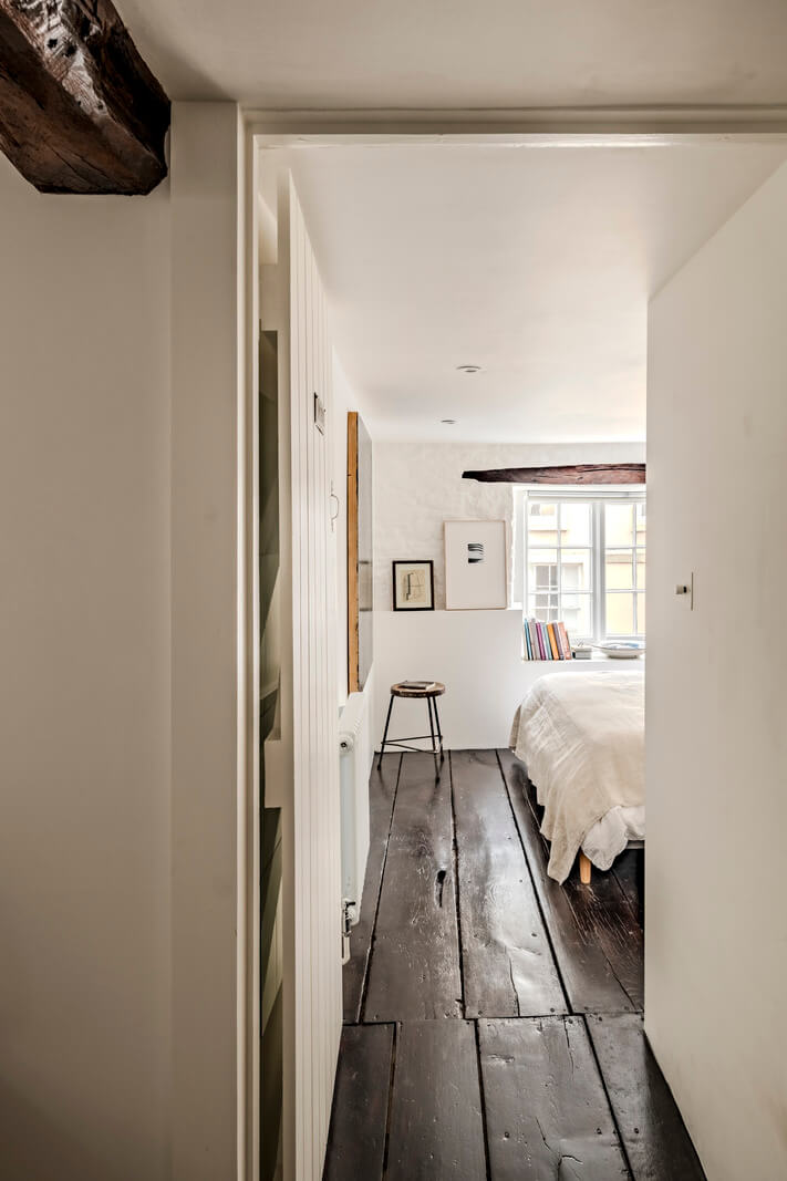 White-Washed Walls and Rustic Elements in a 17th Century Townhouse 19 rustic dark timber floorboards white bedroom
