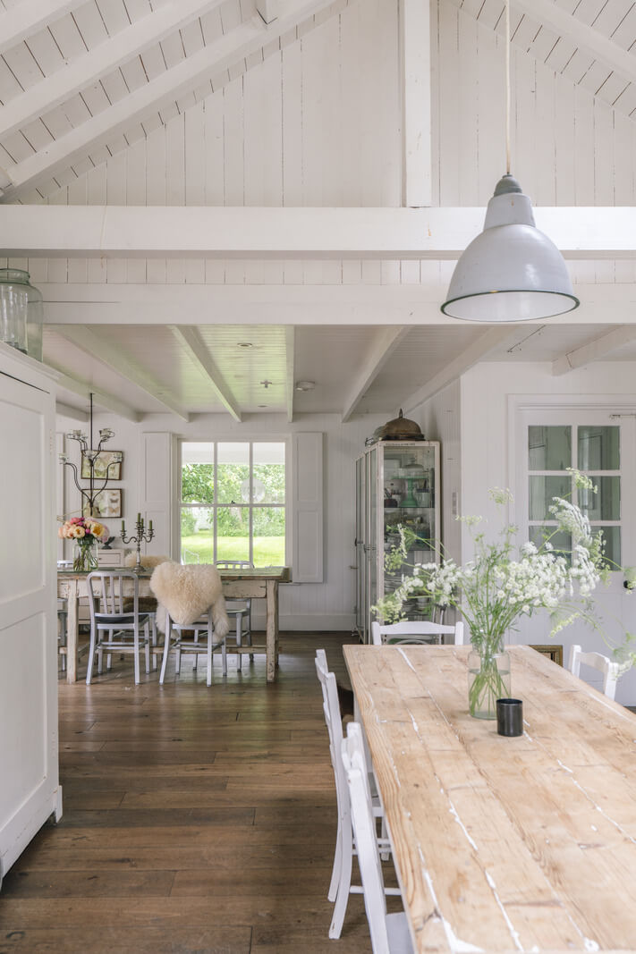 A Bright New England-Style Home with a Lush Garden 4 rustic dining table pitched ceiling