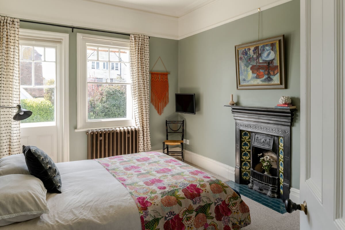 A Grand Edwardian Villa with a Yellow Kitchen and Coastal Views 24 sage green bedroom fireplace