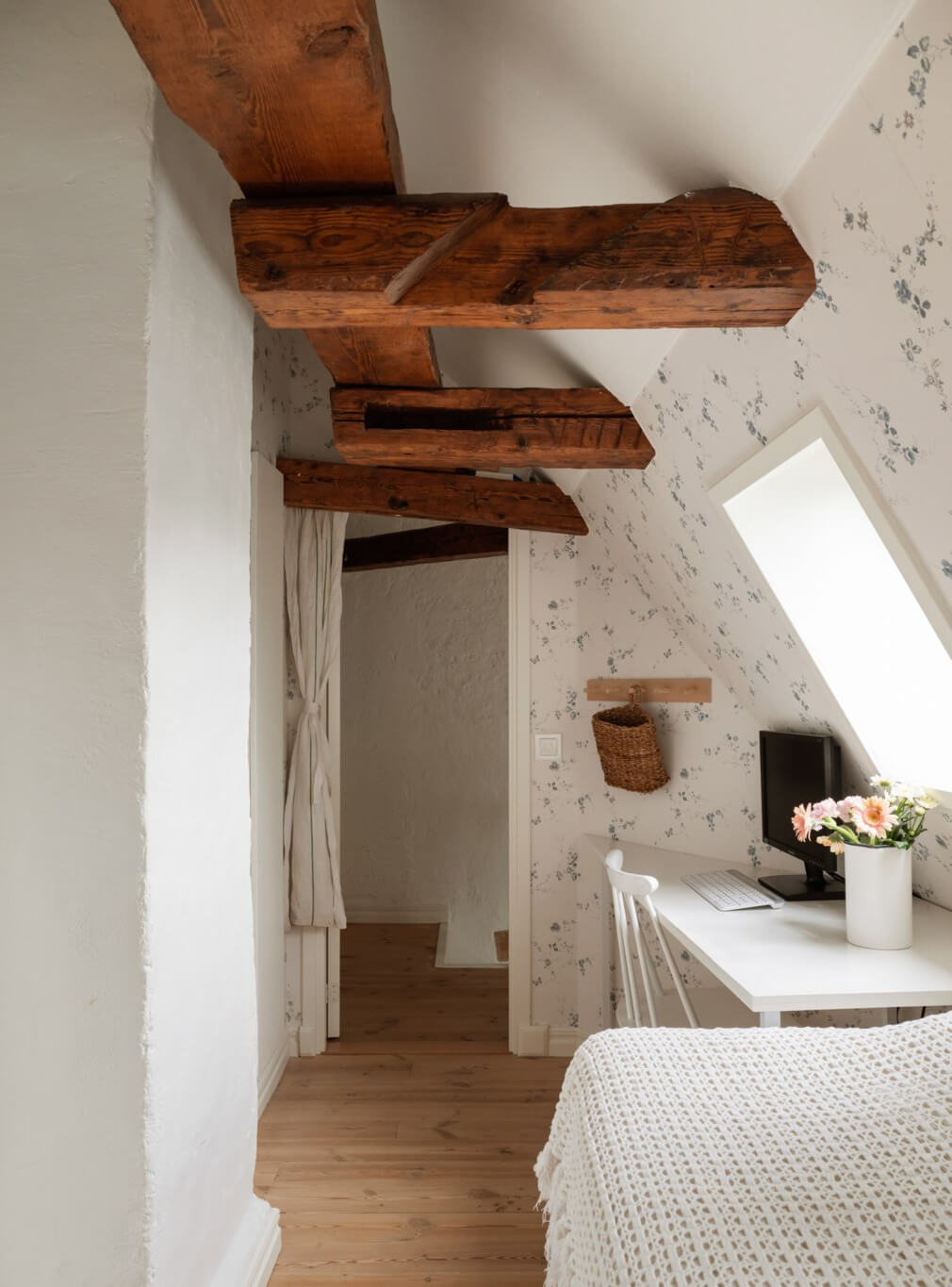 A Charming Attic Apartment in Stockholm's Gamla Stan 20 small bedroom white desk floral wallpaper