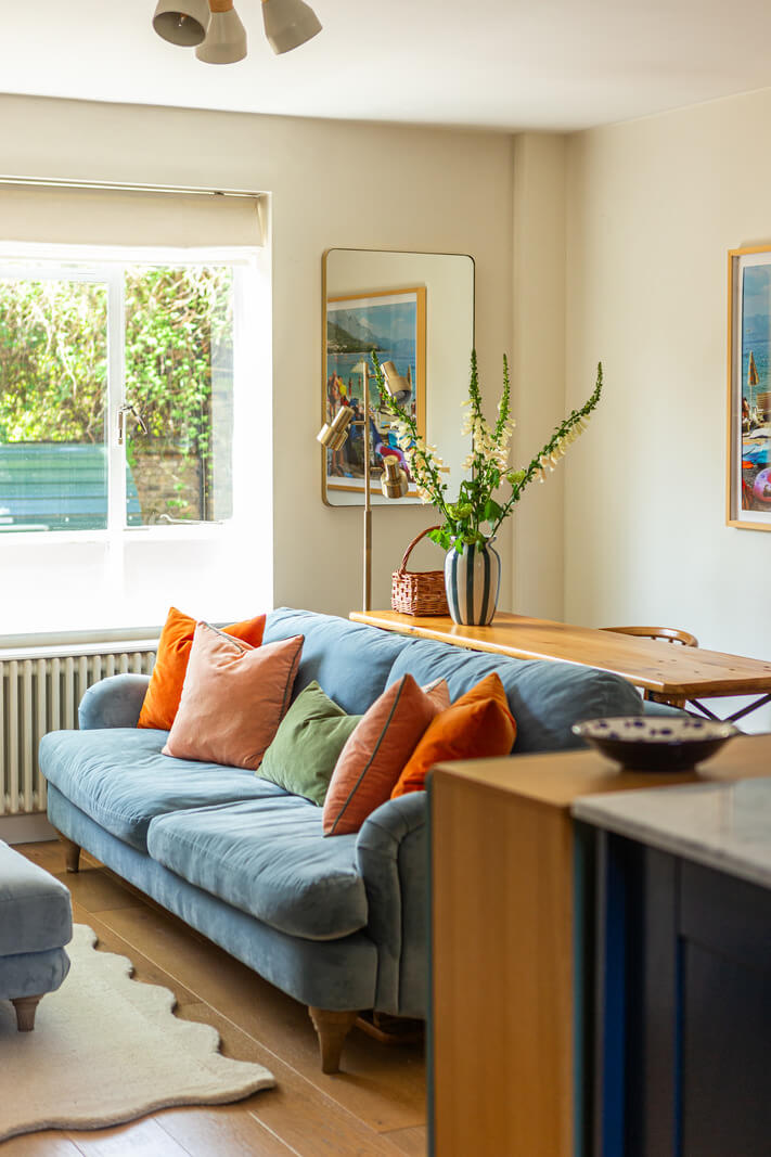 An Open-Plan Living Space and Colorful Bedrooms in a London Duplex 2 small living room table behind sofa
