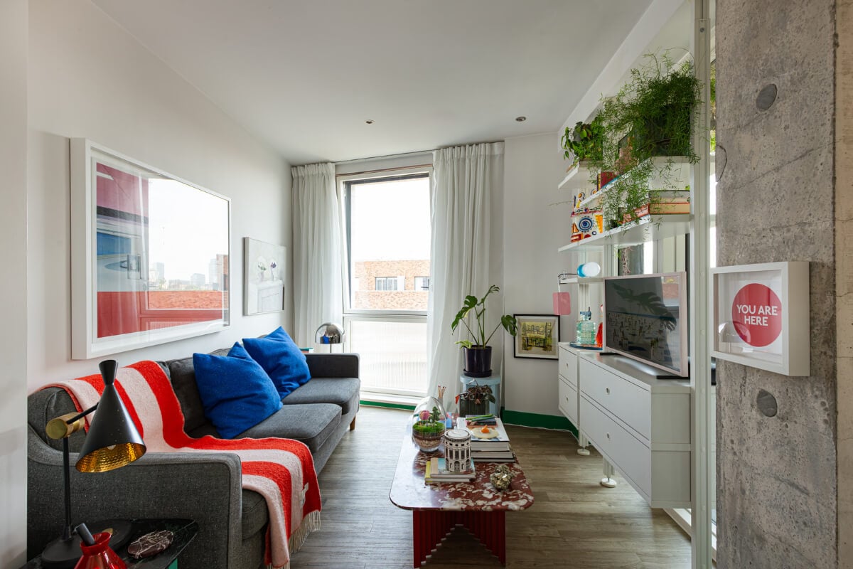 Playful Colors in a Modern One-Bedroom Apartment in London 3 small living room white shelving system