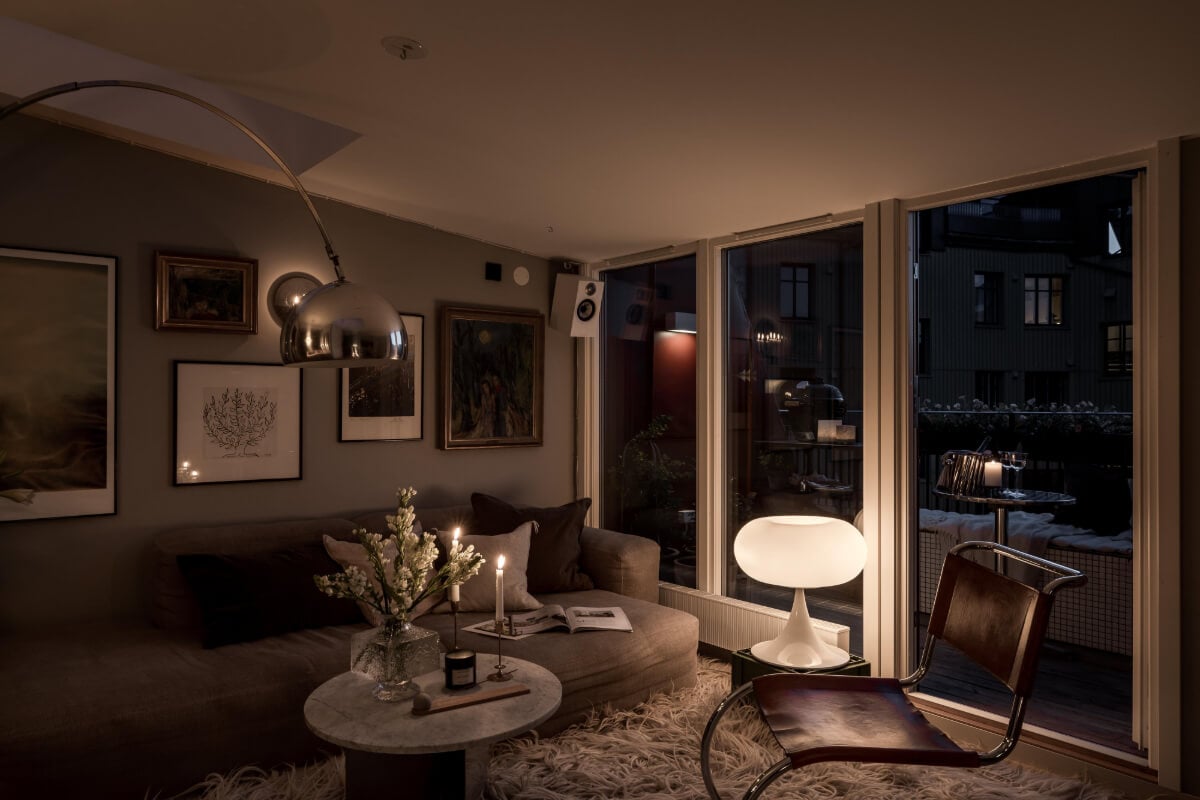 A Small, Cozy Attic Apartment with a Large Terrace 6 small scandi living room at night