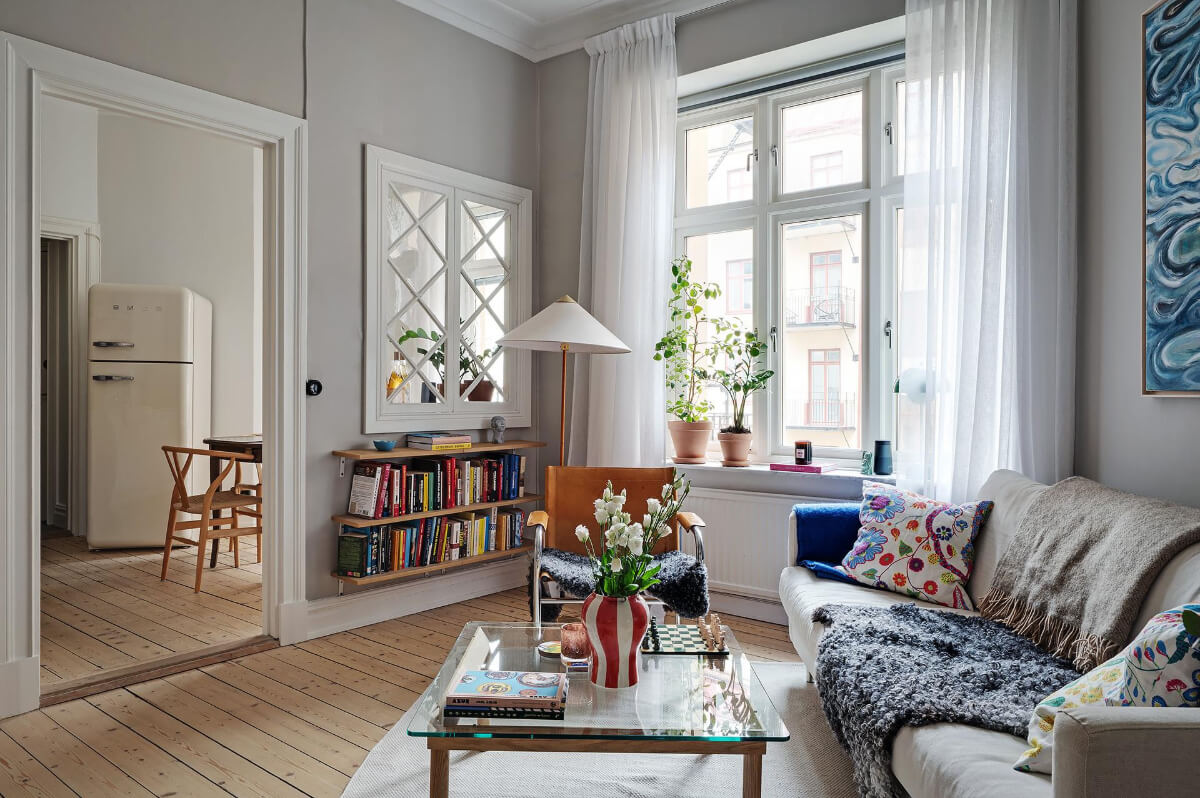 Classic Elements in a Charming Swedish Studio Apartment 1 studio-apartment-gray-walls-inner-window-to-kitchen