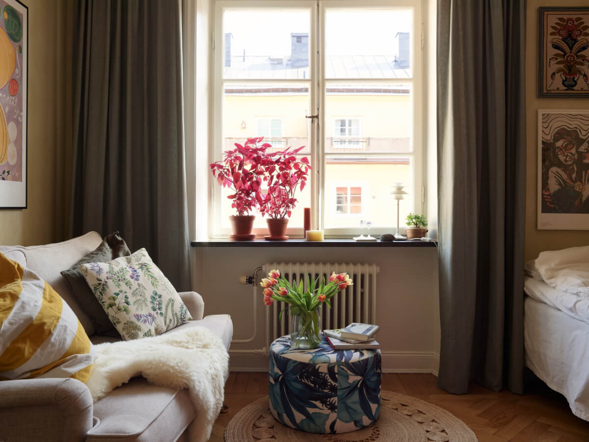 Warm Walls and Original Elements in a Swedish Studio Apartment 2 studio apartment large window