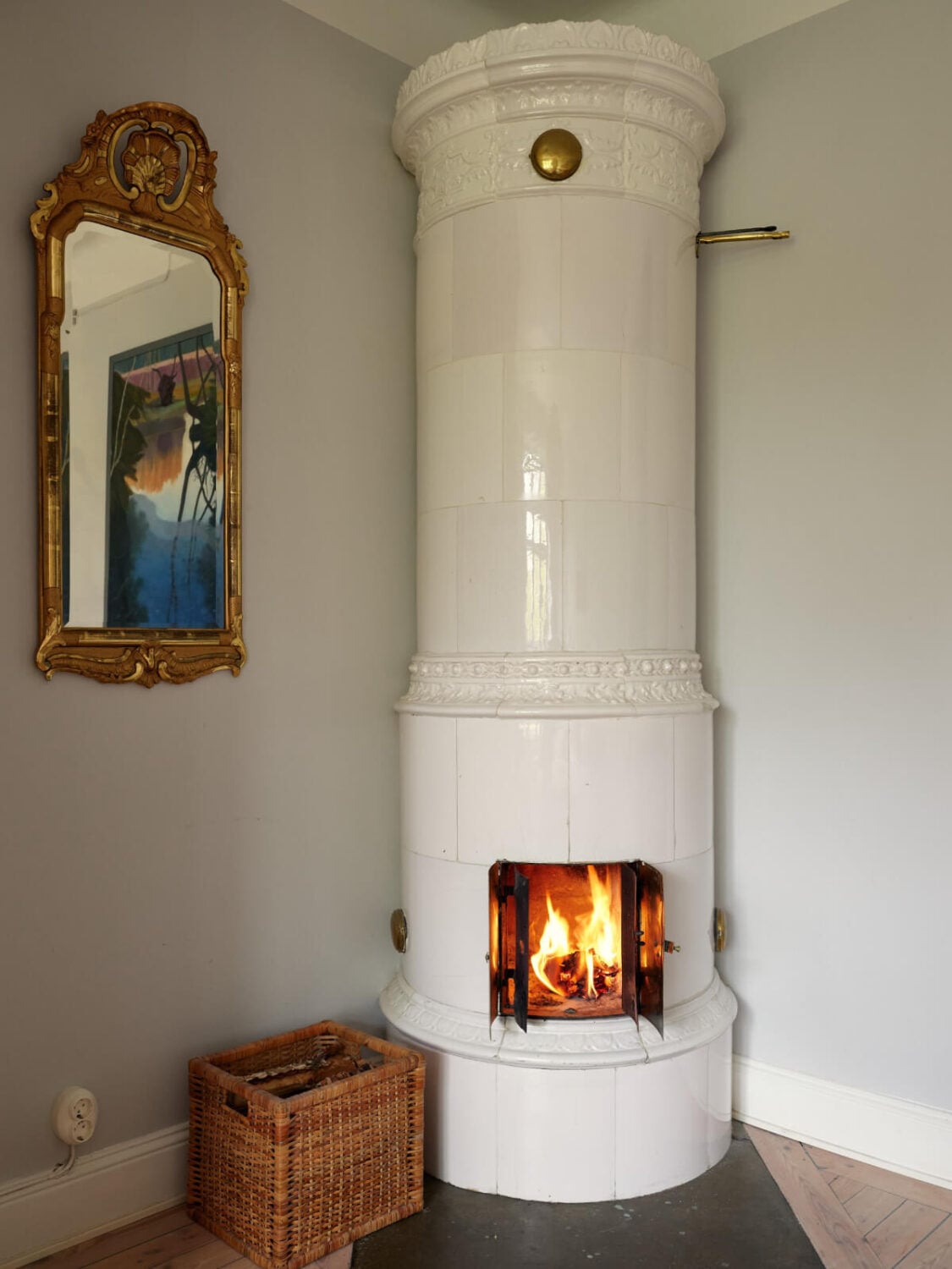 An Art Nouveau Apartment with a Deep Green Kitchen 17 swedish fireplace kakelugn gilded mirror