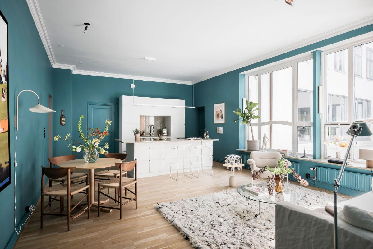 A Teal Green Living Room and Large Windows in a Swedish Apartment 1 teal green open plan living space white kitchen large windows