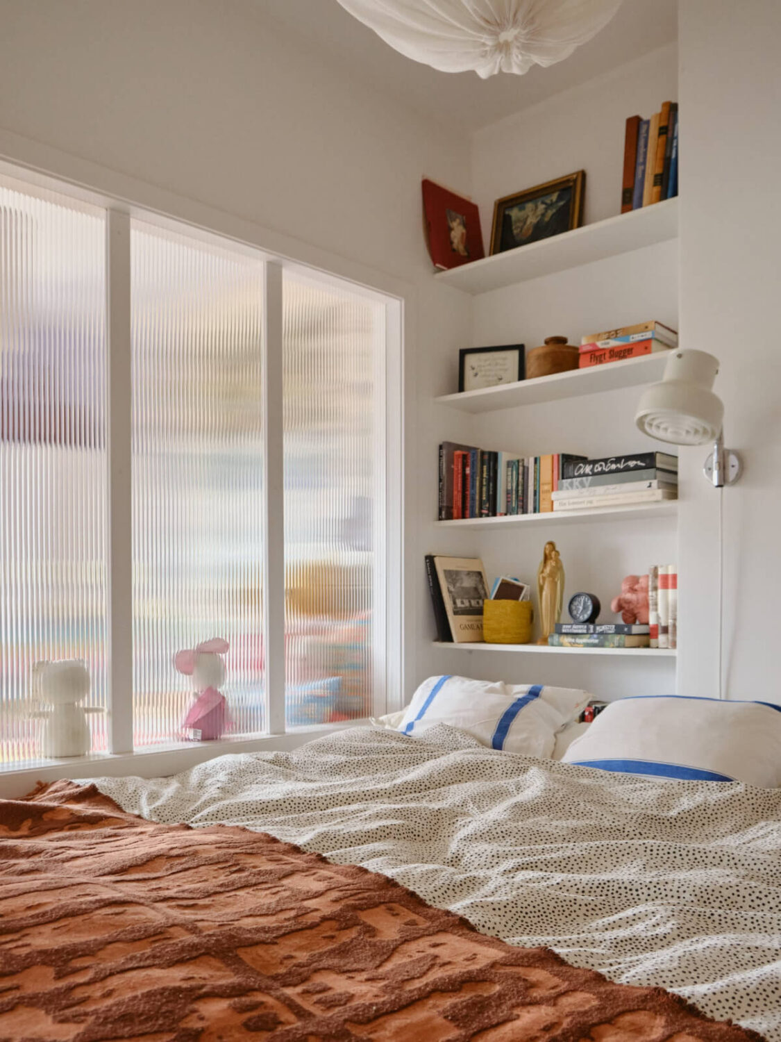 A Colorful 1940s Apartment with Original Elements 27 tiny bedroom built-in shelves ribbed glass room divider