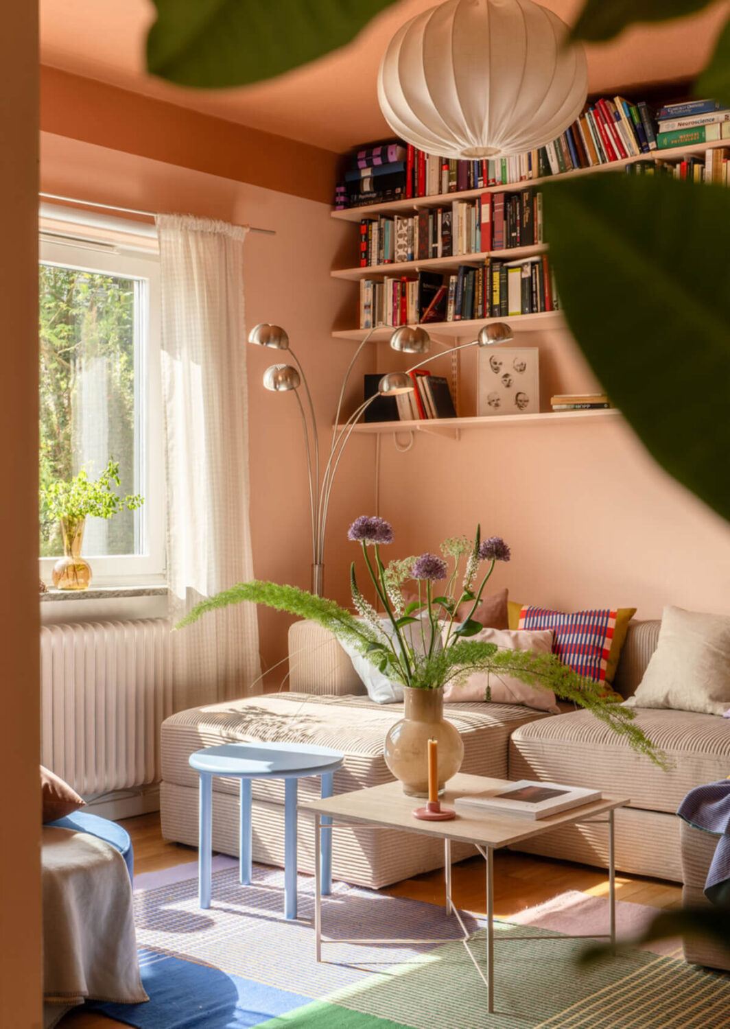 A Stylish and Joyful Color and Material Palette in a Midcentury Apartment 2 two tone pink living room colorful rug