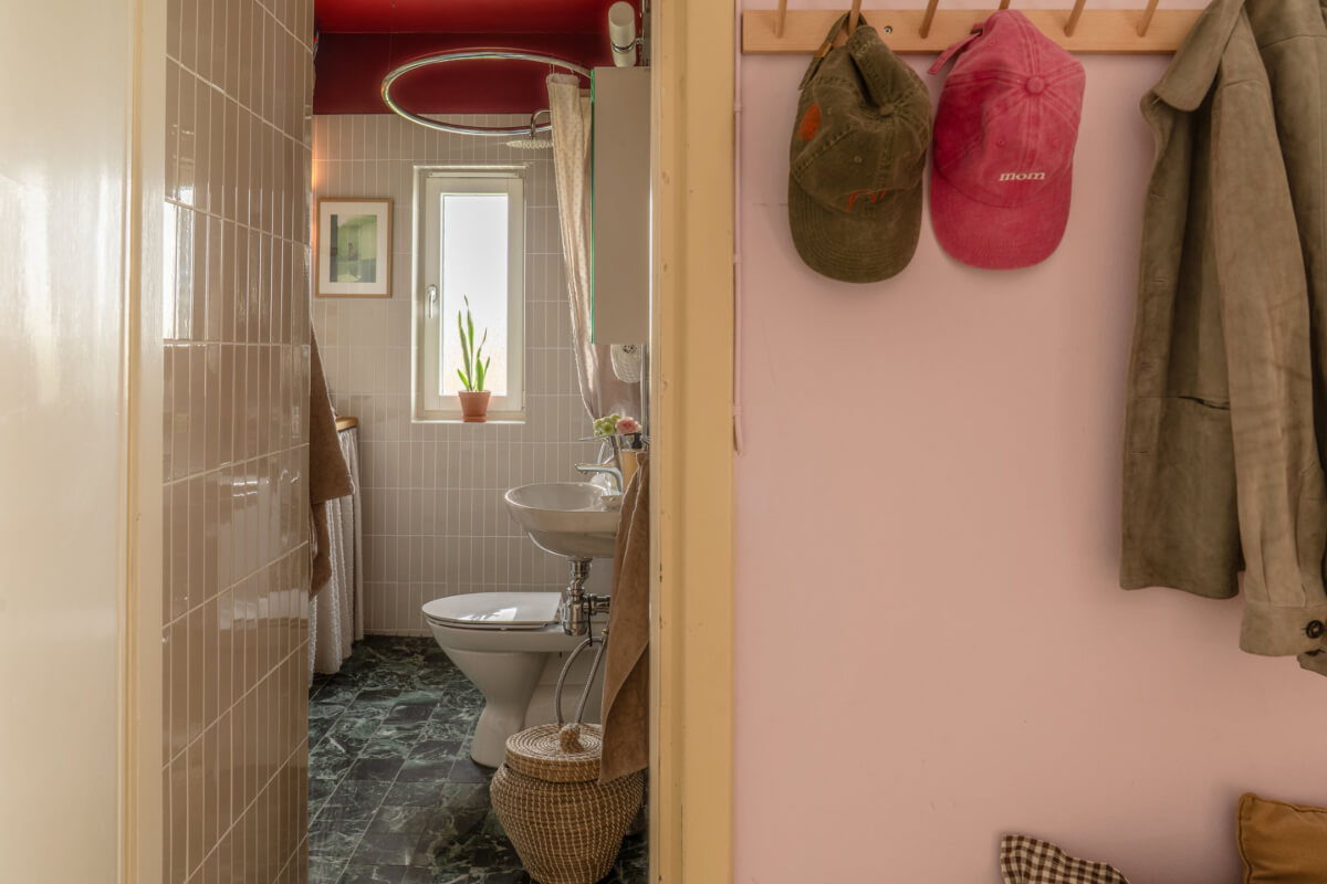 A Stylish and Joyful Color and Material Palette in a Midcentury Apartment 24 view into bathroom