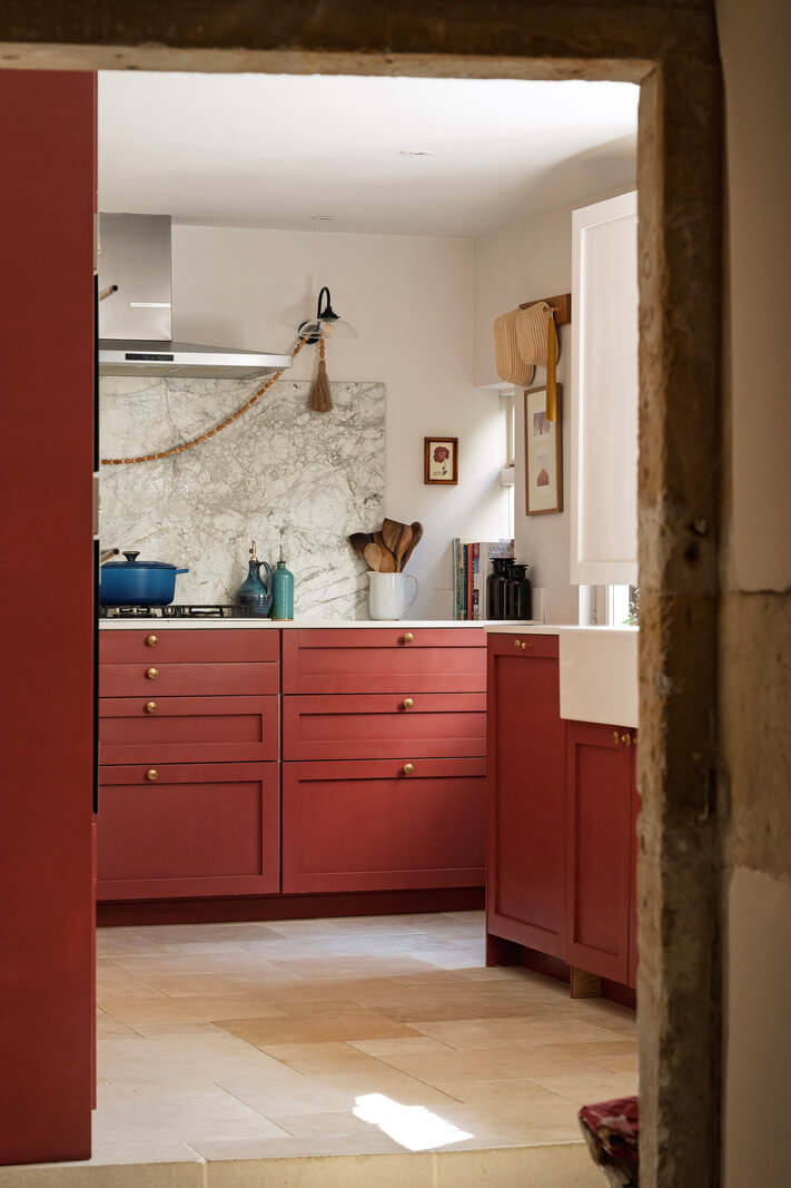 A Family Home with a Cheerful Color Palette in a Historic House 8 view into kitchen red cabinets