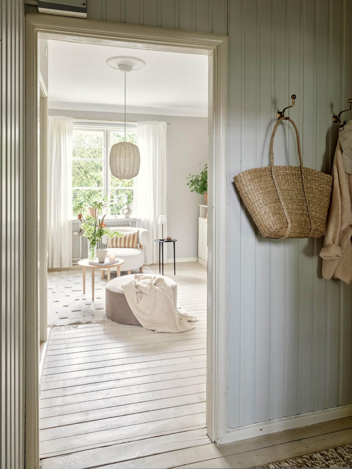 An Apartment with Original Details and a Stunning Period-Style Bathroom 11 view into living room from hall