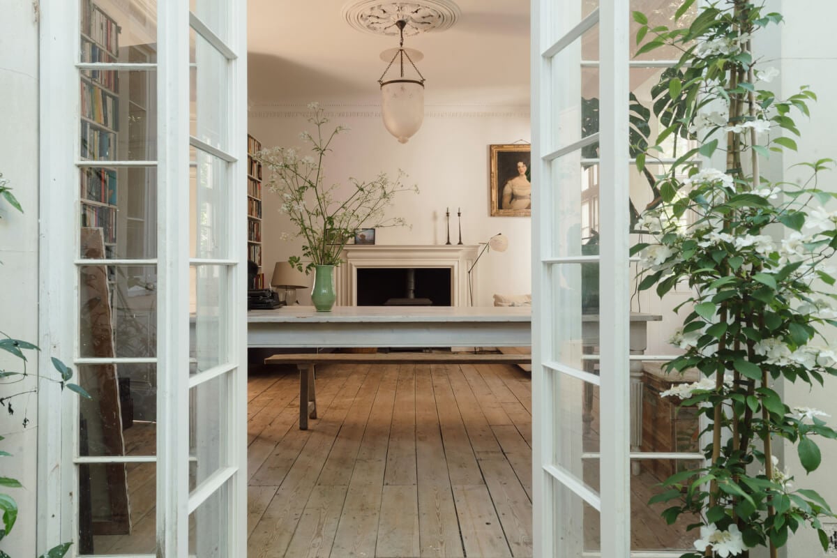 Grand, Light-Filled Spaces in a Gothic-Style English Coastal Home 4 view into living room glass garden doors