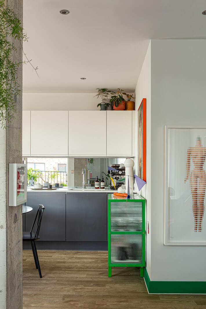 Why Everyone’s Adding Mirrors to Their Kitchens (And You Should Too) 10 view into modern kitchen mirror backsplash