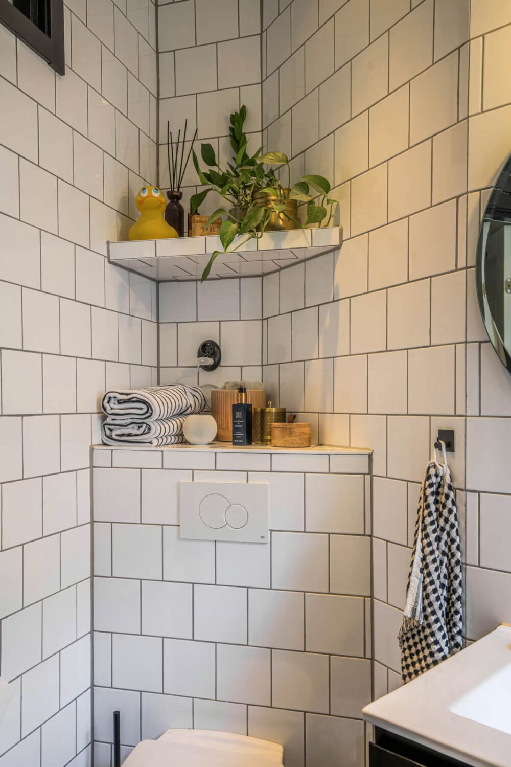 A Spacious One-Bedroom Apartment in Gothenburg 14 white bathroom tiles shelves above toilet nordroom A Spacious One-Bedroom Apartment in Gothenburg